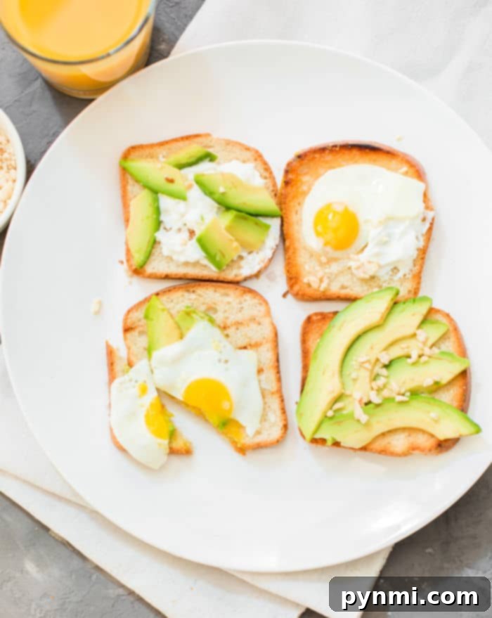 Freshly made avocado toast on a wooden board, showcasing the perfect crispness achieved by making toast in the oven.