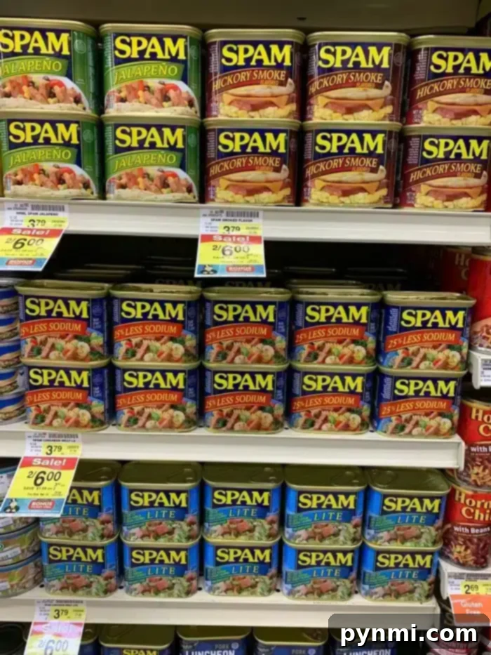 Crispy Air Fryer Spam Fries 4 Shelves stocked with various flavors of Spam, including Spam Fries, Jalapeño, Hickory Smoke, 25% Less Sodium, and Lite. Price tags and promotions are visible beneath the cans.