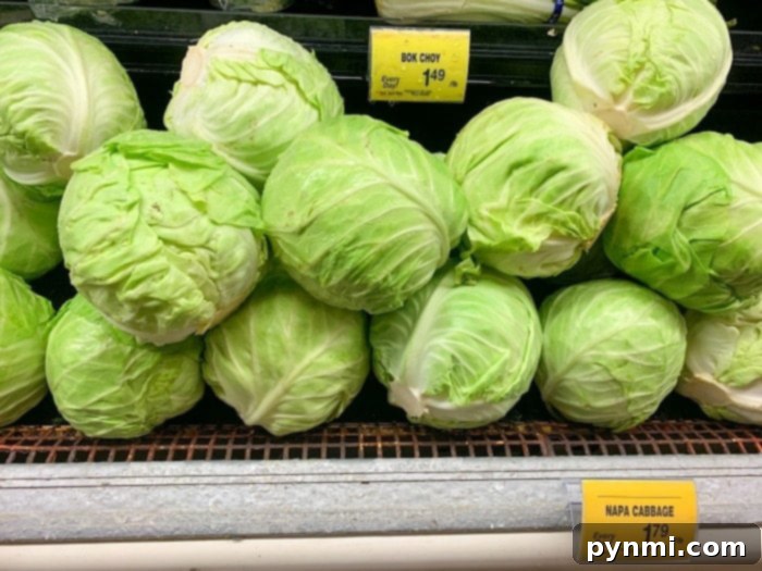 Zesty Quick Cabbage Pickle 3 A fresh, vibrant head of green cabbage on a light surface, ready to be prepared for pickling.