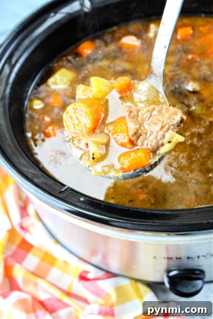 Hearty Slow Cooker Beef Stew with a Secret Onion Soup Mix Kick 2 Hearty Slow Cooker Beef Stew with Onion Soup Mix, garnished with fresh parsley.