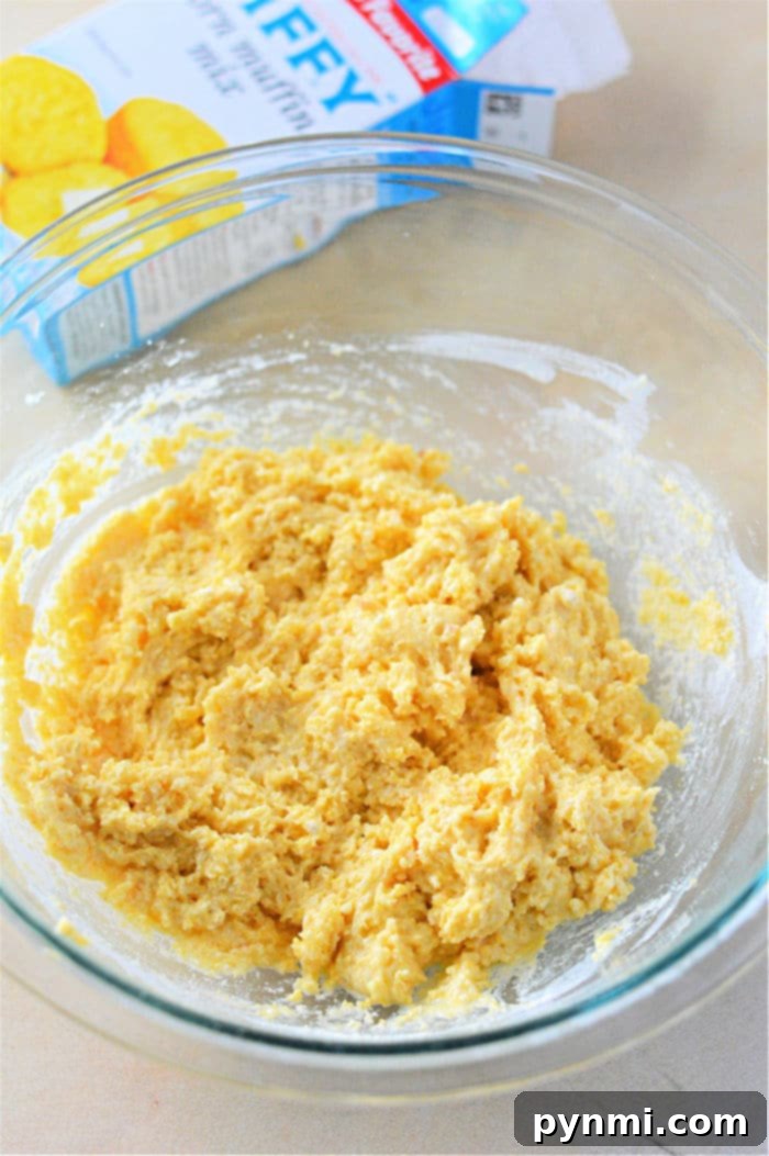 Thick, ready-to-fry hush puppies batter in a mixing bowl, showing its ideal consistency.