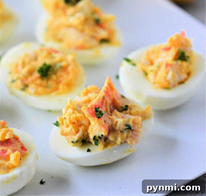 Decadent Crab Deviled Eggs 2 Delicious crab deviled eggs garnished with fresh parsley, a perfect appetizer.