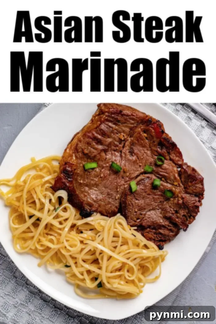 Ultimate Asian Steak Marinade 6 A white plate features grilled steak topped with chopped green onions, accompanied by a side of noodles. The text "Asian Steak Marinade" is displayed at the top. The plate rests on a gray surface with a light-colored napkin partially visible.