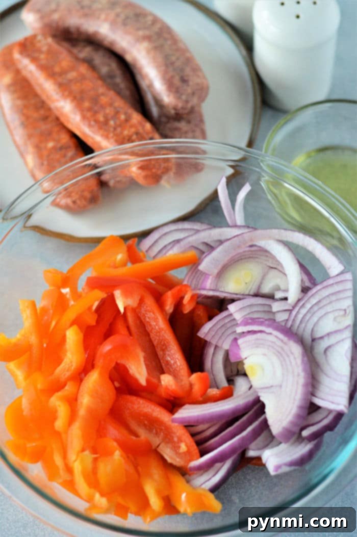 Effortless Oven Bratwurst Perfection 4 Sheet pan bratwurst with fresh, vibrant bell peppers and onions before baking