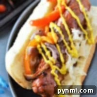 A delicious baked sausage topped with peppers, onions, sauerkraut, and mustard in a bun awaits you on a plate. If you're curious about how to cook bratwurst in the oven for this flavorful experience, you're just a few steps away from perfection.
