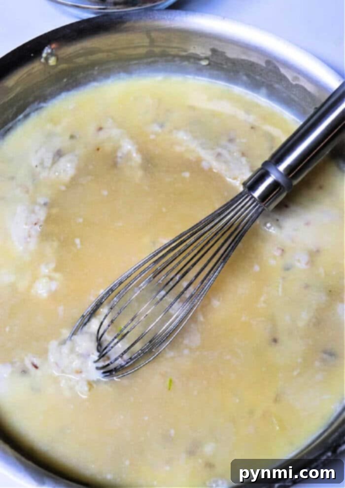 Rich, homemade gravy made from chicken drippings, ready to be served over a meal.