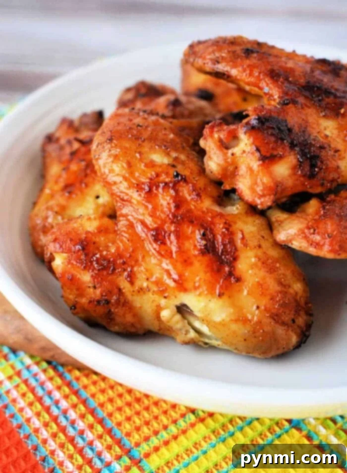 Crispy whole chicken wings cooked in an air fryer, seasoned with a dry rub.