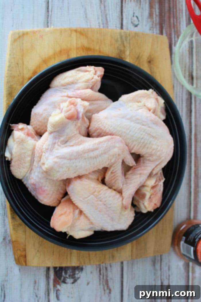 Platter of perfectly air-fried whole chicken wings with a golden-brown, crispy skin.