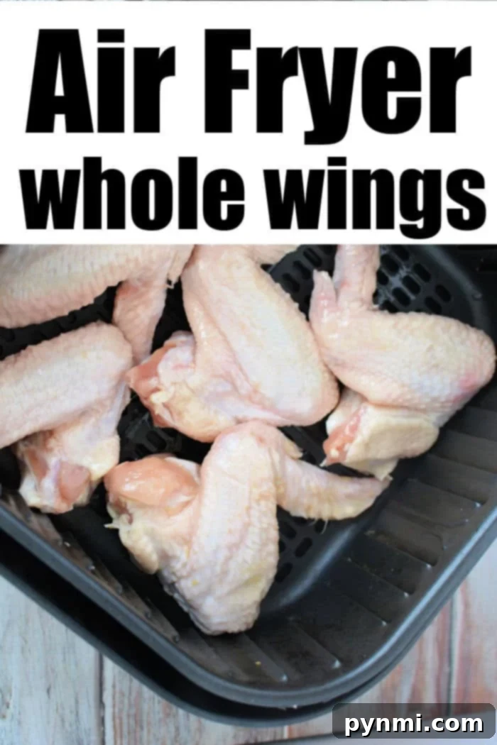 A basket full of uncooked whole chicken wings, perfectly seasoned with dry rub, ready for the air fryer.