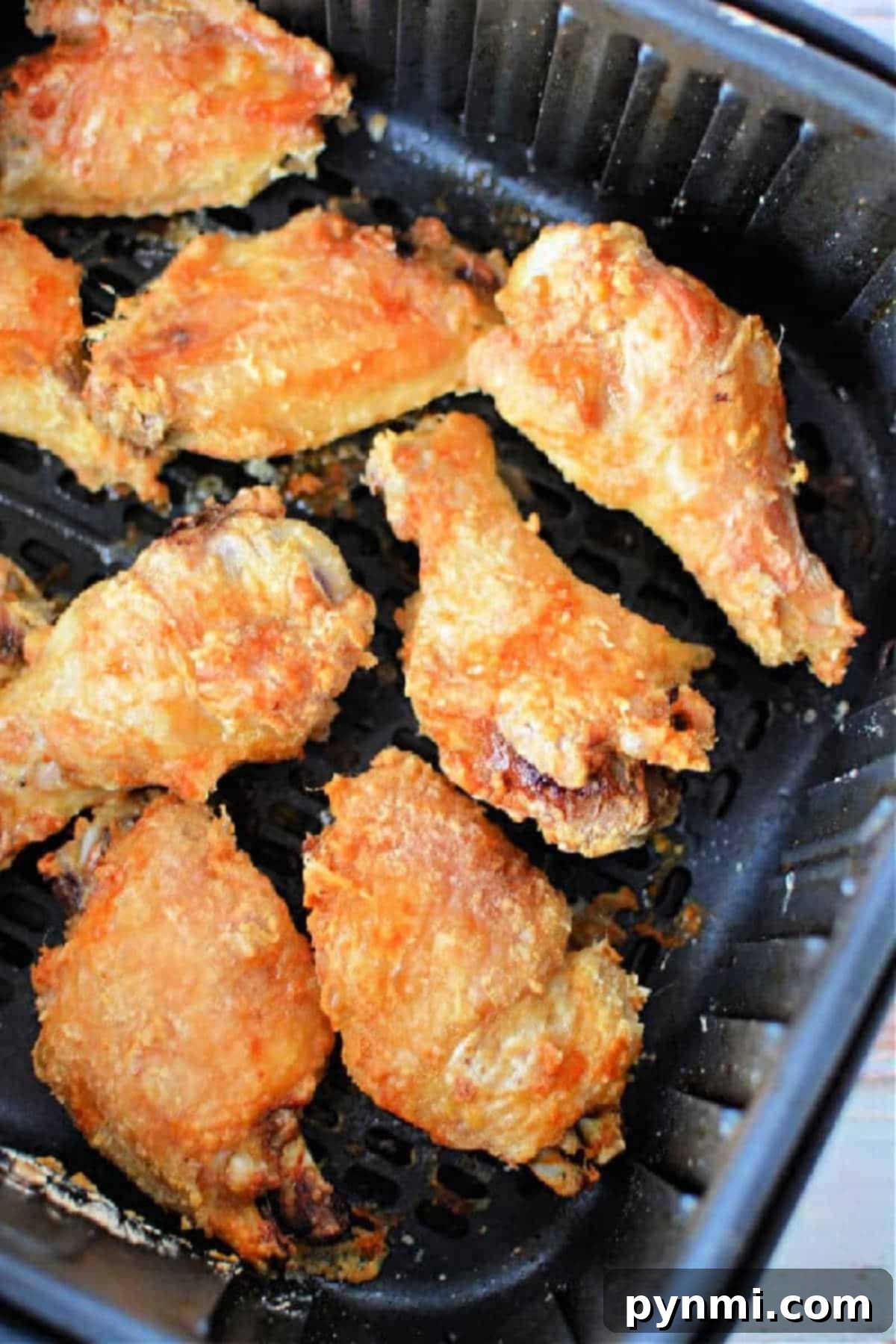 Crispy Air Fryer Wings Baking Powder Secret 2 Crispy Air Fryer Chicken Wings made with a touch of baking powder, perfectly cooked in an air fryer basket.