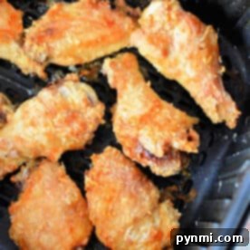 Crispy Air Fryer Chicken Wings made with a touch of baking powder, perfectly cooked in an air fryer basket.
