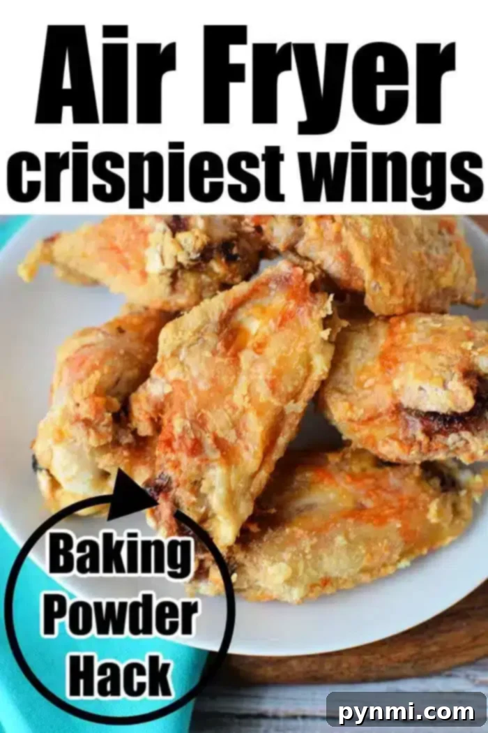 Crispy Air Fryer Wings Baking Powder Secret 8 A white plate filled with crispy Air Fryer Chicken Wings sits on a wooden surface with a turquoise napkin beside it. The text on the image reads "Air Fryer crispiest wings" at the top and "Baking Powder Hack" in a black circle on the left side.