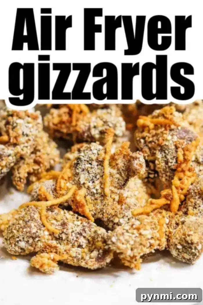 Close-up image of perfectly fried chicken gizzards covered in a light, golden breading on a white surface, with bold text "Air Fryer Chicken Gizzards".