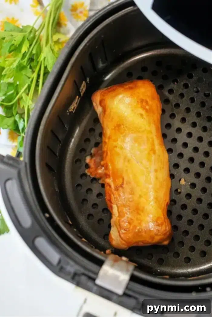 Perfecting Your Hot Pocket Cook Time 7 An air-fried burrito in an air fryer basket.