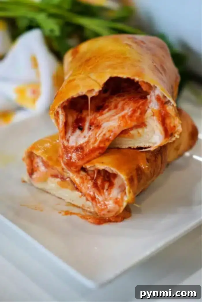 Perfecting Your Hot Pocket Cook Time 8 A close-up shot of two slices of stromboli stacked on a white plate.