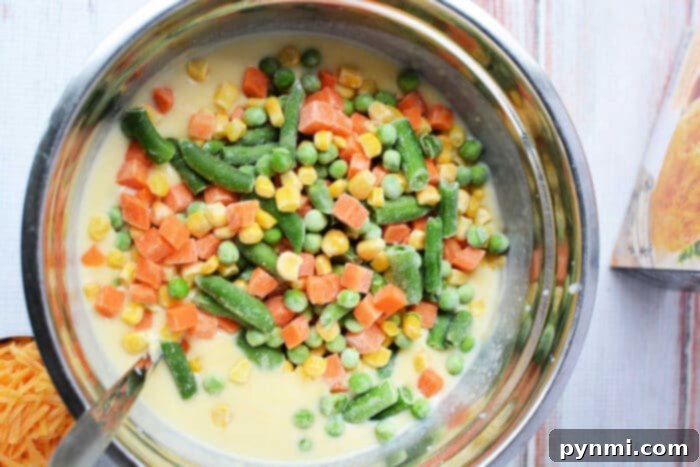Creamy chicken pot pie filling with mixed frozen vegetables.