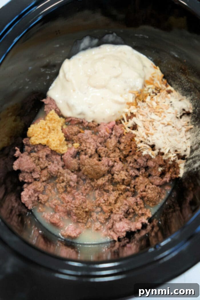 Slow Cooker Beef Stroganoff with Ground Beef 4 Ingredients being combined in the slow cooker.
