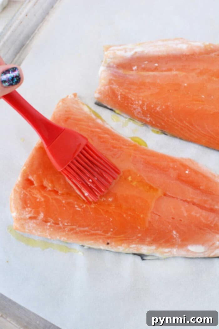 Brushing oil onto frozen salmon fillets