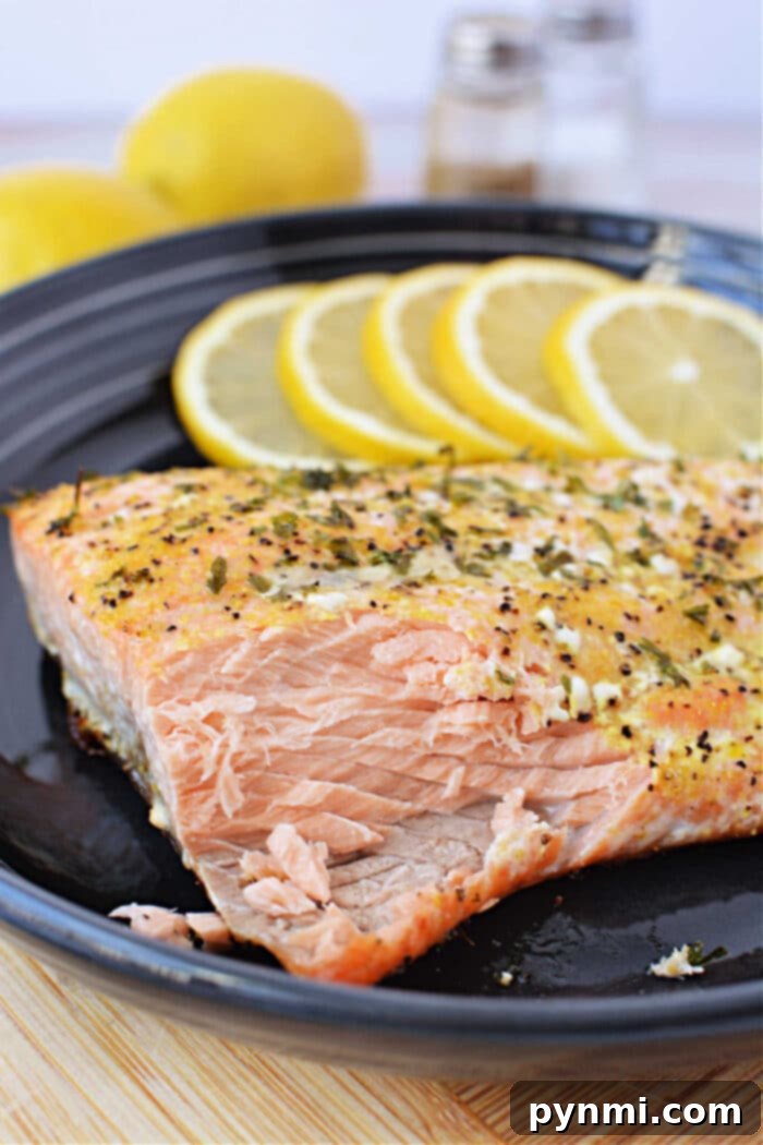 Baked frozen salmon served with herbs and lemon slices