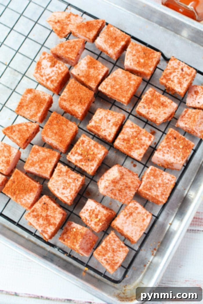 Cubes of bologna coated with chili powder, ready to be served.