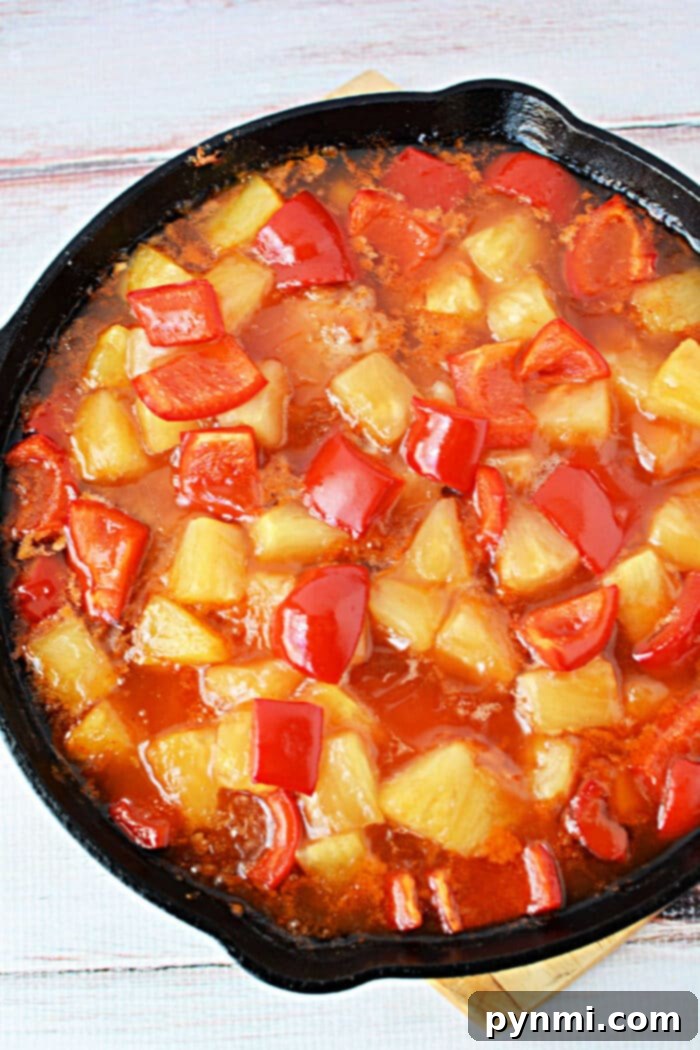 Tropical Pork Chops 6 A skillet filled with sweet and sour sauce, pineapple chunks, red bell peppers, and tender pork chops—perfect for trying new pork chop recipes.