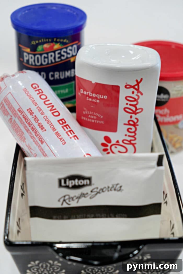 Ultimate BBQ Glazed Meatloaf 3 A rustic basket filled with the core ingredients for a delicious BBQ Meatloaf Recipe: fresh ground beef, a bottle of Chick-fil-A sauce, Lipton onion soup mix, classic bread crumbs, and a can of cream of chicken soup.