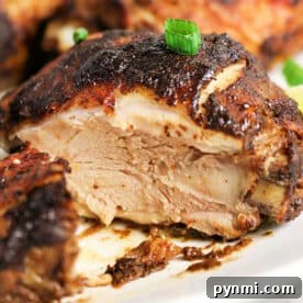 Oven-Baked Jerk Chicken Recipe – Crispy, Flavorful & Authentic 7 A close-up of juicy, oven jerk chicken with crispy, seasoned skin, garnished with chopped green onions.