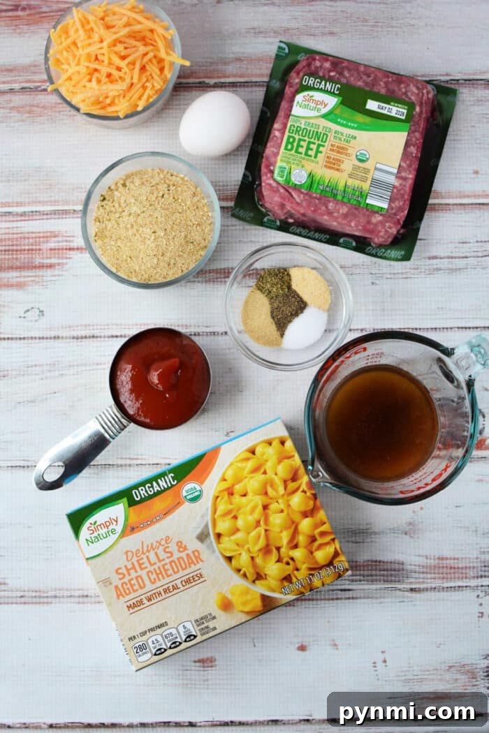 Mac and Cheese Meatloaf Casserole Recipe for Comfort Dinner 3 Ingredients for a cheesy casserole, blending pasta, ground beef, cheese, egg, broth, sauce, and seasonings—like a tasty mash-up of cheeseburger and classic mac and cheese.