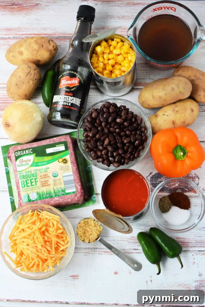 Slow Cooker Cowboy Casserole 3 Ingredients for a Cowboy Casserole: potatoes, corn, black beans, cheese, beef, jalapeños, onion, spices, broth, and sauce—perfect for an easy Crockpot Tex-Mex meal.