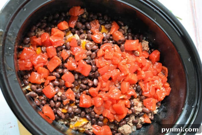 Slow Cooker Cowboy Casserole 5 Black beans, ground meat, and diced tomatoes layered in a Crockpot make this Cowboy Casserole an easy and hearty Crockpot recipe ready to be cooked.