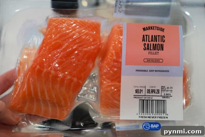 Sticky Teriyaki Salmon Bites Recipe with Sesame Glaze 4 Packaged Atlantic salmon fillets labeled Marketside Atlantic Salmon Fillet Skinless in a clear plastic container—perfect for making Teriyaki Salmon Bites at home.