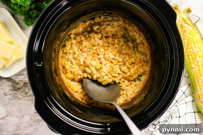 Slow Cooker Creamed Corn 5 Crockpot Creamed Corn in a slow cooker with a serving spoon, fresh corn, butter, and herbs on the side.